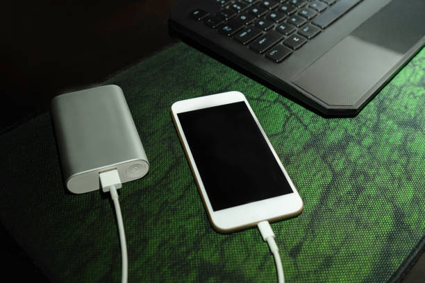 istock Mobile smart phone charging wirelessly by sharing battery via device. 1256302818