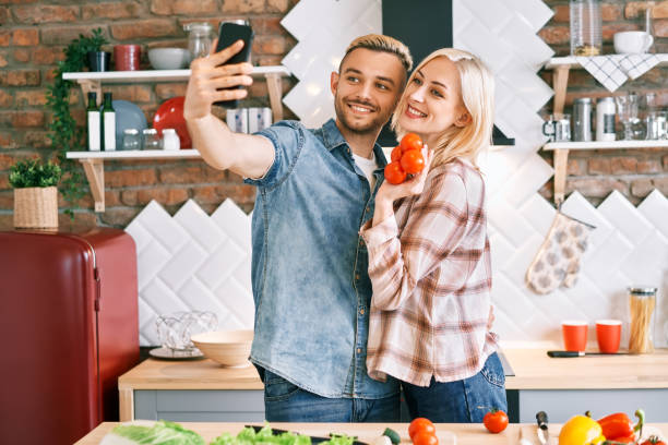 istock oung happy couple take selfie at their kitchen 1256303214