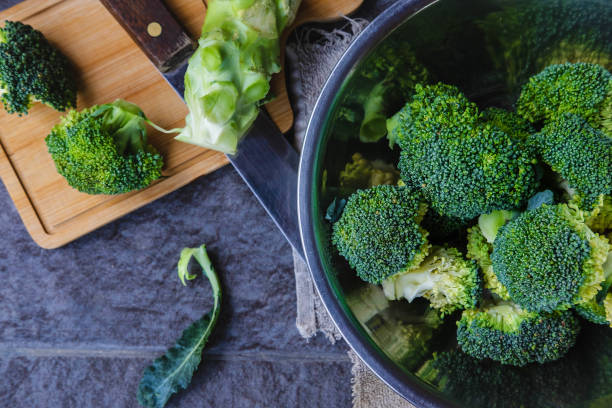 istock Raw broccoli cut in a wooden chopping board 1256304072