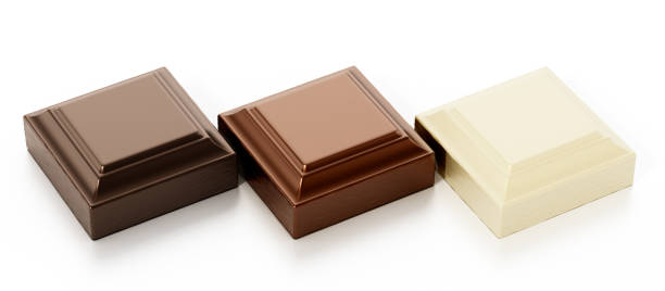 istock White, brown and black chocolate pieces isolated on white 1256304378