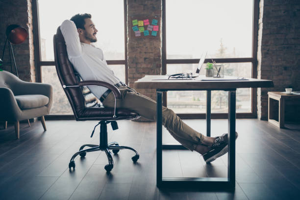istock Profile side view of his he nice attractive chic elegant confident cheerful man qualified expert shark sitting in chair having rest at modern loft brick industrial style interior workplace station 1256304483