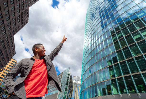 istock Low Angle View Of Man Standing By Building Against Sky 1256306229