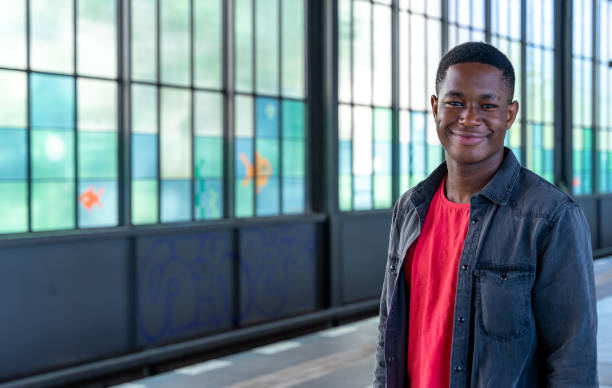 istock Portrait Of Smiling Man Standing Against Window 1256306248