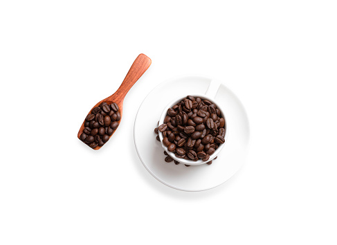Coffee cups with full coffee beans and a spoon to scoop the coffee beans on the side.