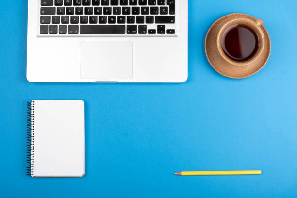 istock Blue office desk knolling with center bottom right copy space 1256306324