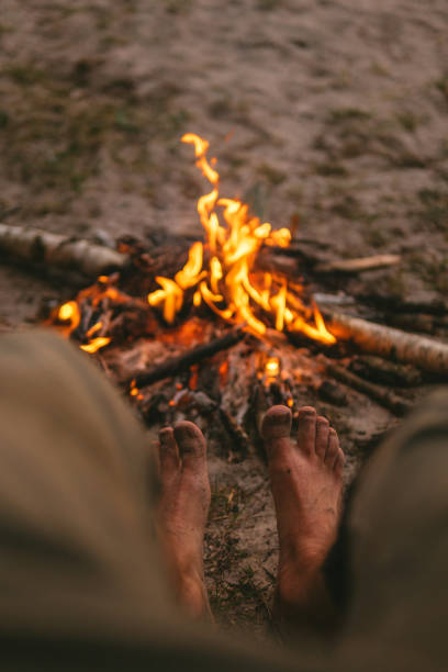 istock Bonfire close up. Man warming up his feet 1256307153