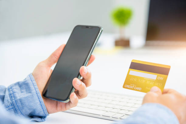 istock Hands holding credit card and using smart phone. 1256307894