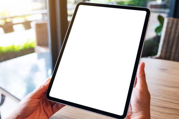 istock a woman holding black tablet pc with blank white desktop screen 1256309106