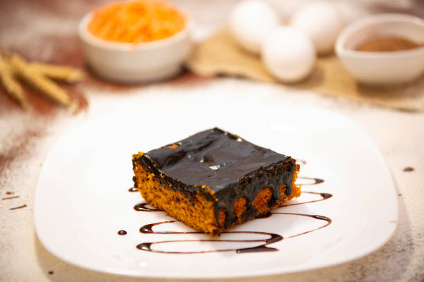 istock Carrot cake with chocolate and slice on the table 1256309158