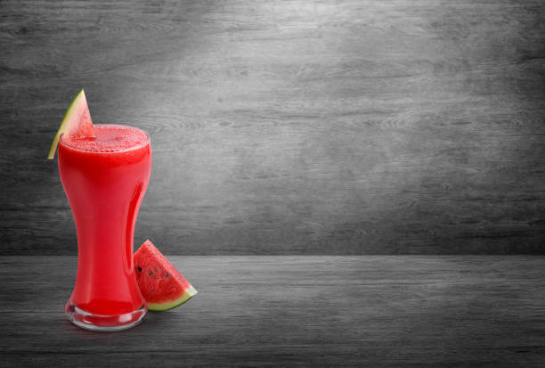 A Glass of Cold Watermelon Smoothie, with sliced watermelon placed on wooden background fresh juice A Glass of Cold Watermelon Smoothie, with sliced watermelon placed on wooden background fresh juice watermelon juice stock pictures, royalty-free photos & images
