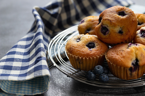Closeup shots of muffins near blueberries.