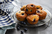 Homemade vanilla muffins with blueberries on a dark concrete background