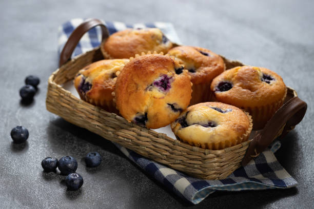 istock Homemade vanilla muffins with blueberries on a dark concrete background 1256310572