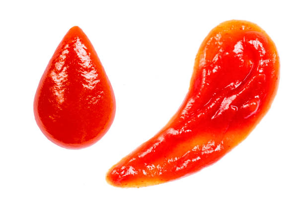 istock Sauce drop and splash isolated on white background. Ketchup or tomato paste 1256311199