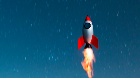 Launch of a space ship. The shuttle travels up in the air. Concept of launching something new with success.