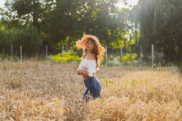 istock Attractive red-haired girl in a wheat field 1256311455