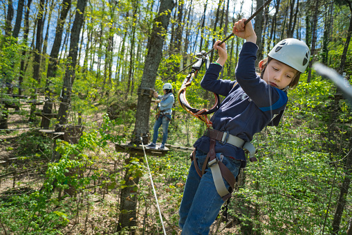 Boy overcomes obstacles in Adventure Rope Park