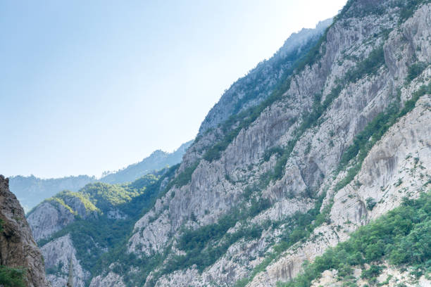 Perspective view at a space between two mountain slopes at sunrise. Summer. Montenegro