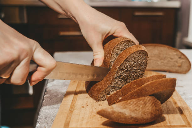 istock Selective focus on slices of rye bread cut from a loaf with a knife. 1256311890