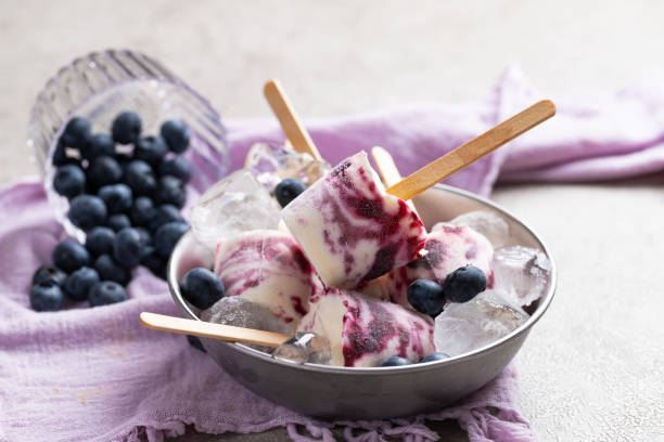 Blueberry ice cream popsicles Ice cream popsicles from homemade Greek yogurt and fresh organic blueberries homemade icecream stock pictures, royalty-free photos & images