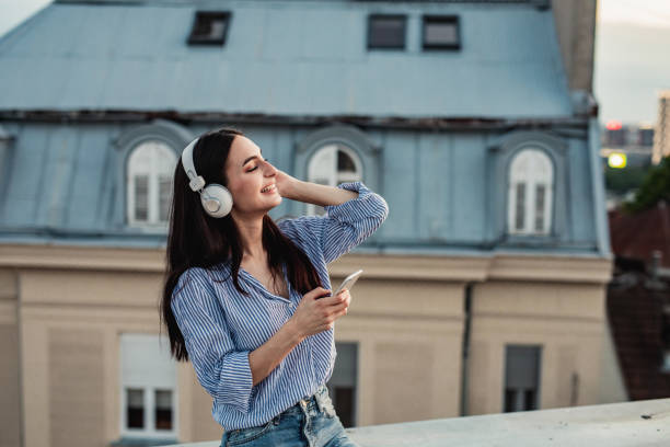 istock Young woman enjoying on the rooftop 1256317251