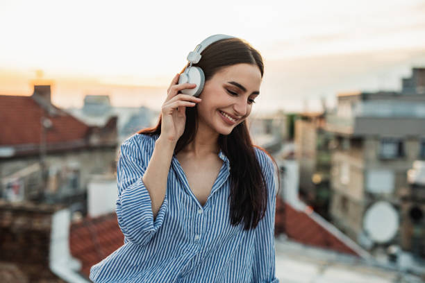 istock Young woman enjoying on the rooftop 1256317505