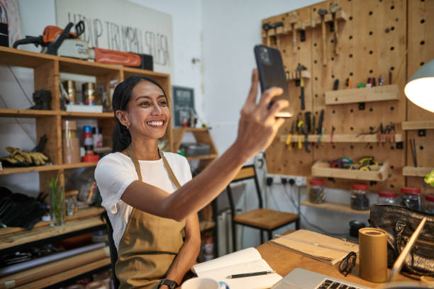 donna asiatica falegname che usa lo smartphone nel suo laboratorio di studio - independence business women manual worker foto e immagini stock