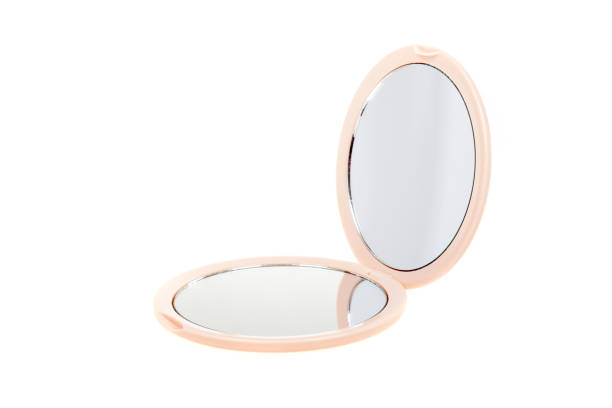 istock Small round cosmetic pocket mirror isolated on white. Open 1256322140