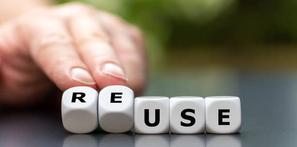 istock Hand turns dice and changes the word use to reuse. 1256322511