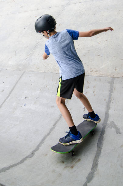 istock Young boy going up on ramp with skateboard 1256322975