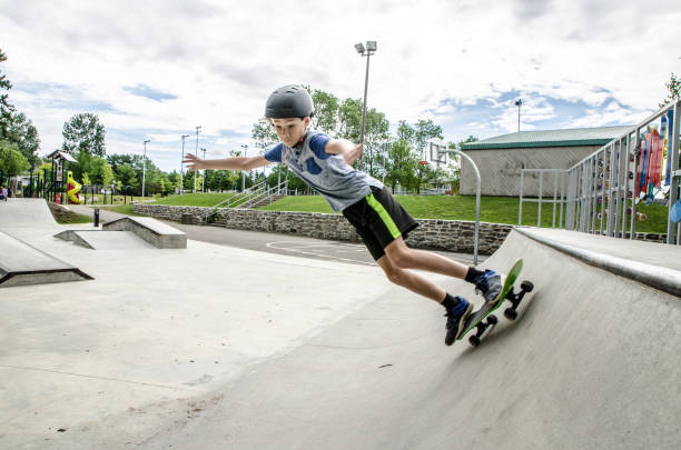 istock Young boy going up on ramp with skateboard 1256323024