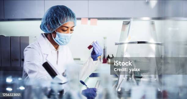 Asian Female Doctor Working With Pathogen Samples Using Microscope Stock Photo - Download Image Now