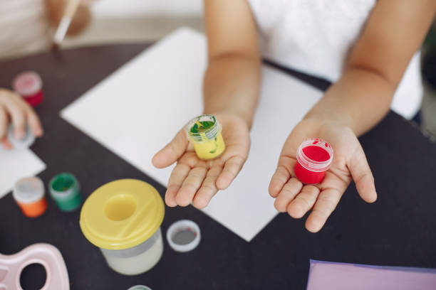 istock Two little girls sitting at class and drawing 1256325584
