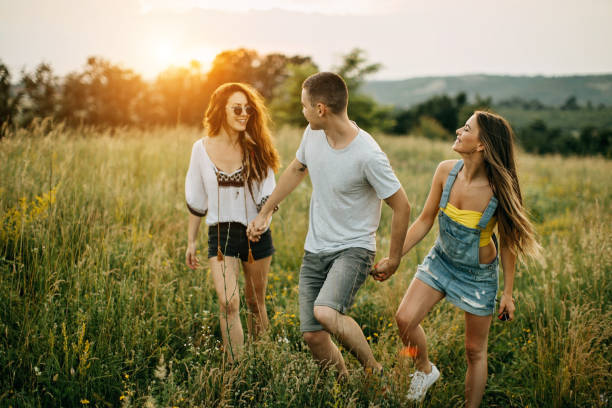 istock Friends enjoying the sunset in nature 1256330065