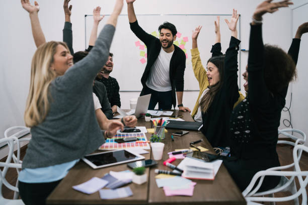 istock Business team celebrating with raised up hands. 1256332650