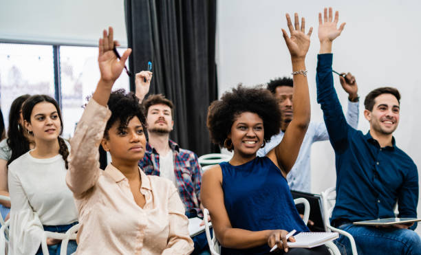 istock Group of young people sitting on conference together. 1256332652