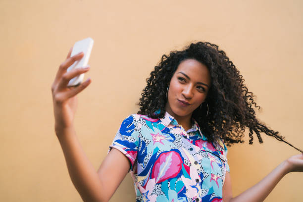 istock Afro woman taking selfies with phone. 1256332672