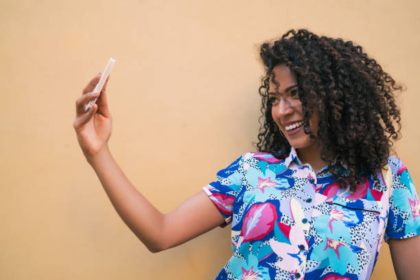 istock Afro woman taking selfies with phone. 1256332675