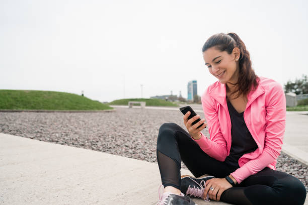 istock Athletic woman using her phone. 1256332706