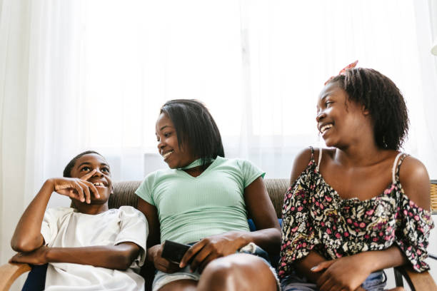 istock Smiling mother and children on the couch 1256332808