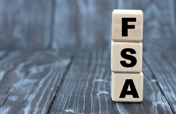 istock concept word FSA on cubes on a beautiful gray blue background 1256333462