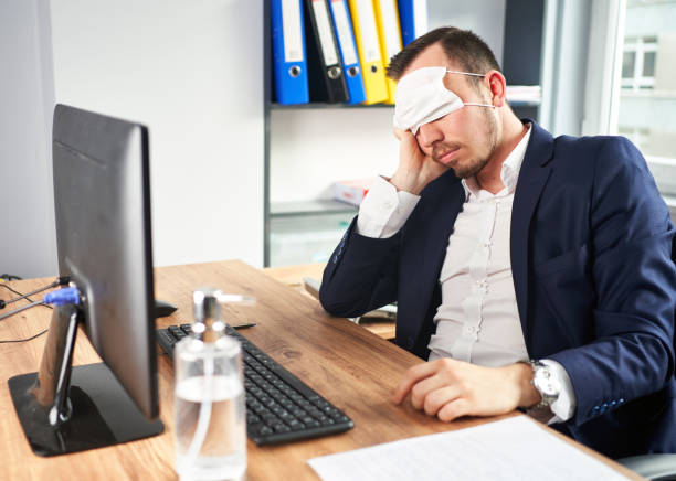 istock businessman in sleeping mask relaxing at workplace 1256334179