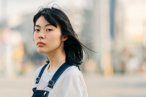 A portrait of a young woman on a windy day.