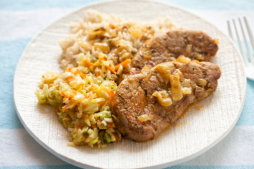 Pork tenderloin in creamy whiskey sauce, with brown rice and salad