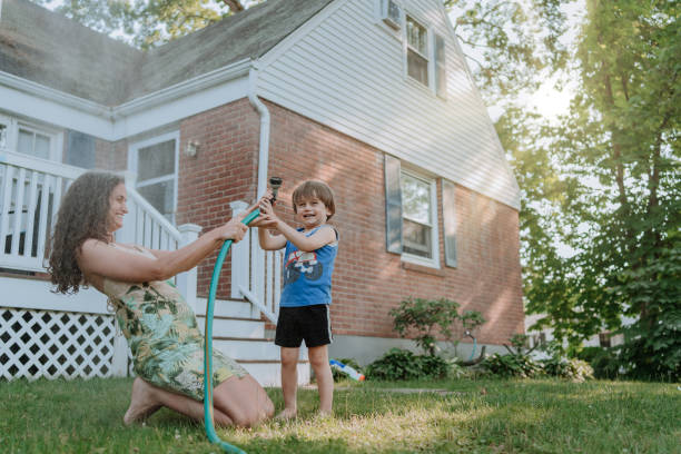 istock Mother and son playing outdoors with water 1256337144