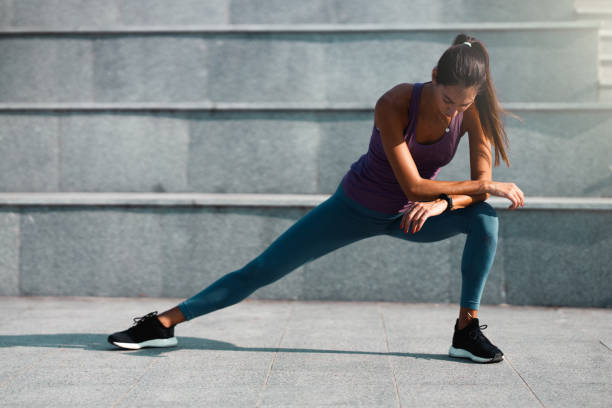 istock Young woman doing a leg stretching exercise 1256337238