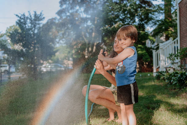 istock Mother and son playing outdoors with water 1256337326