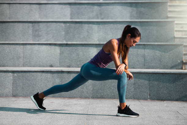 istock Young woman doing a leg stretching exercise 1256337462