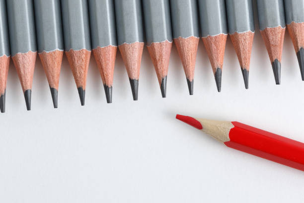 istock Support Group, Intervention. Conceptual. Red and gray pencils opposite each other on an isolated background 1256337487