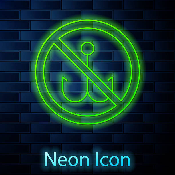 istock Glowing neon line No fishing icon isolated on brick wall background. Prohibition sign. Vector 1256337844